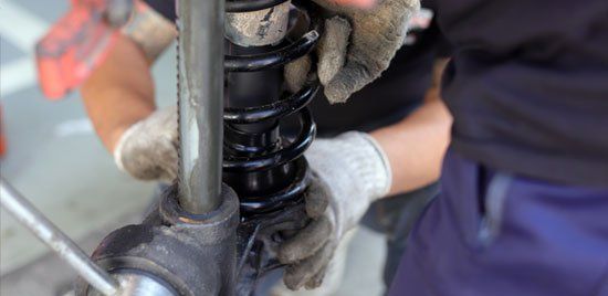 Mechanic Repairs the Shock Absorber and Spring — Elmira, NY — Steve's American Lifetime Muffler