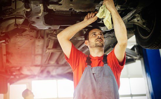 Mechanic Repairs the Car — Elmira, NY — Steve's American Lifetime Muffler Mechanic Repairs the Car — Elmira, NY — Steve's American Lifetime Muffler