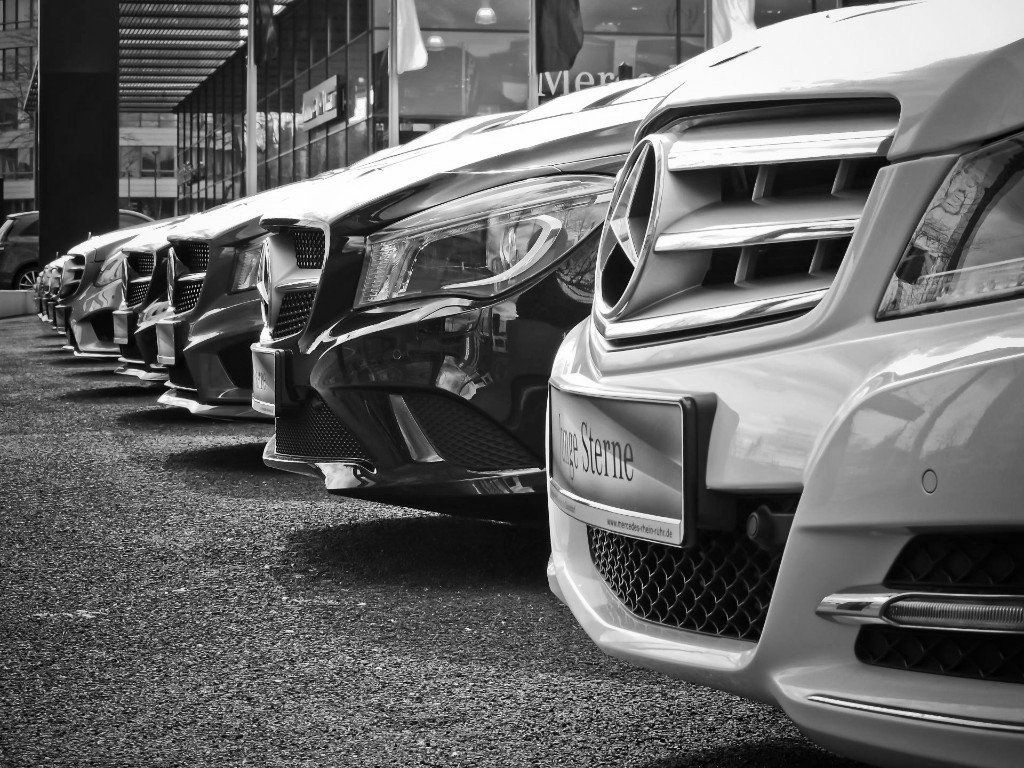 A black and white photo of a row of mercedes benz cars dent repair Grand Junction