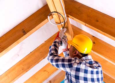 Man fixing bulb of house — Home Electrician in York, PA