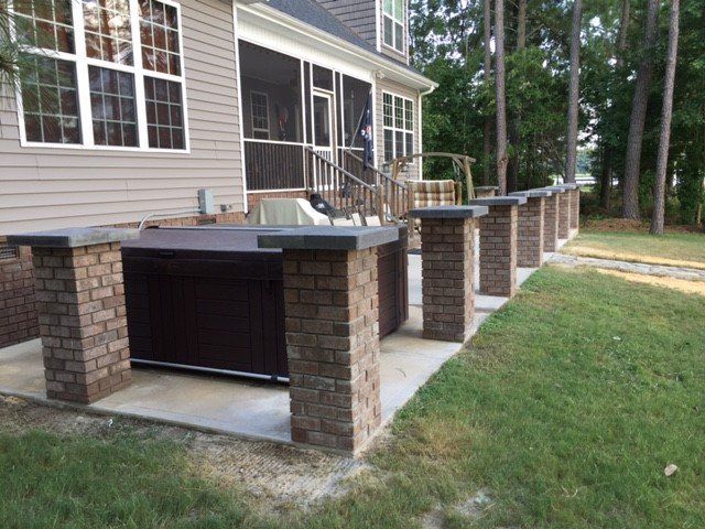 A row of brick pillars in front of a house