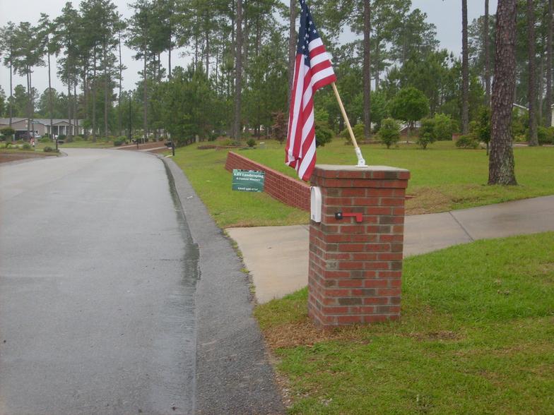 A brick post with an american flag on it