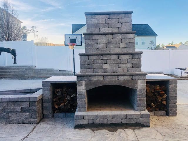 A brick fireplace with a basketball hoop in the background