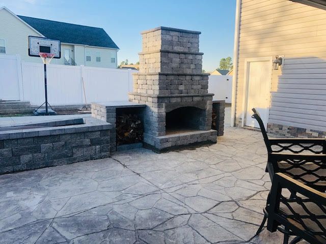 A patio with a fireplace and a basketball hoop