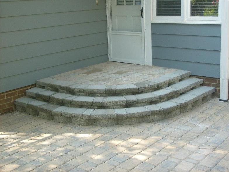 A set of curved steps leading up to a door