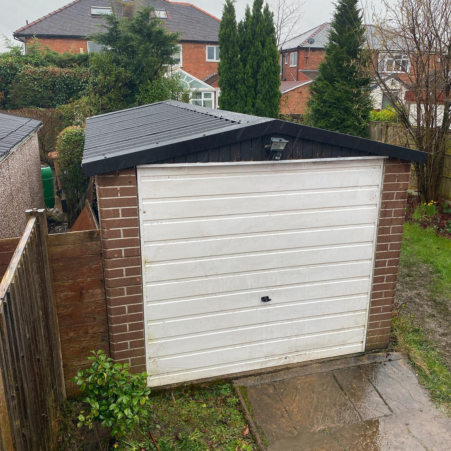 Workman applying sheets to garage roof