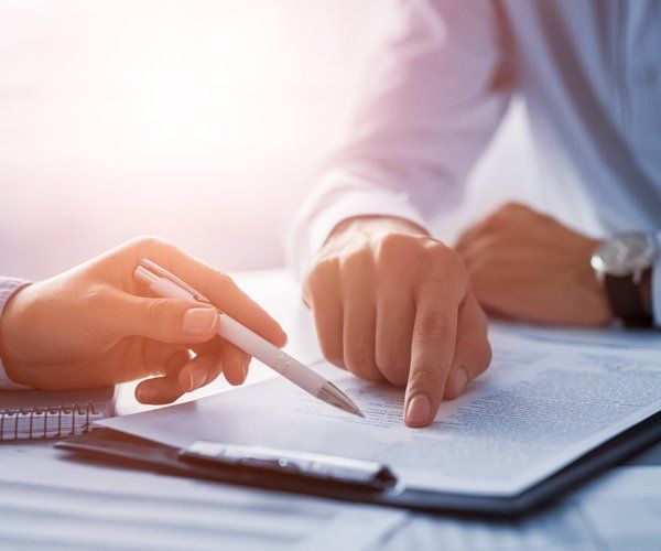 Human Hands Working with Documents — Bozeman, MT — Buckley Law Office