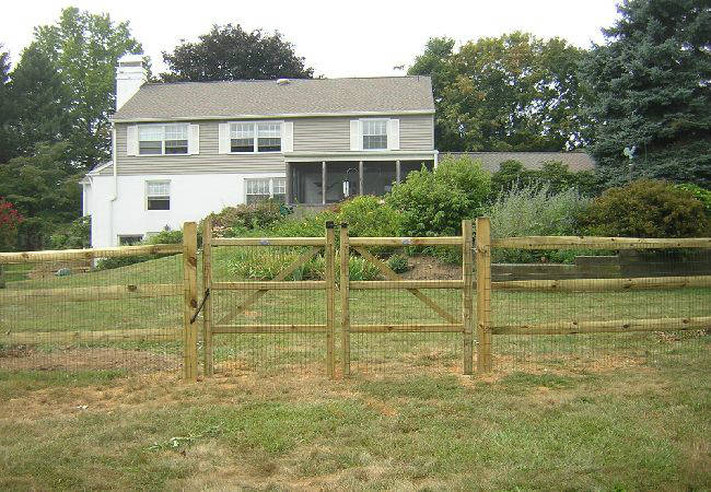 A house with a wooden fence in front of it