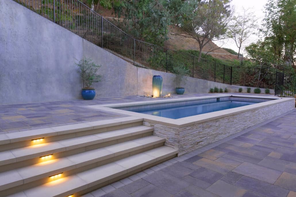 A large swimming pool with stairs leading to it