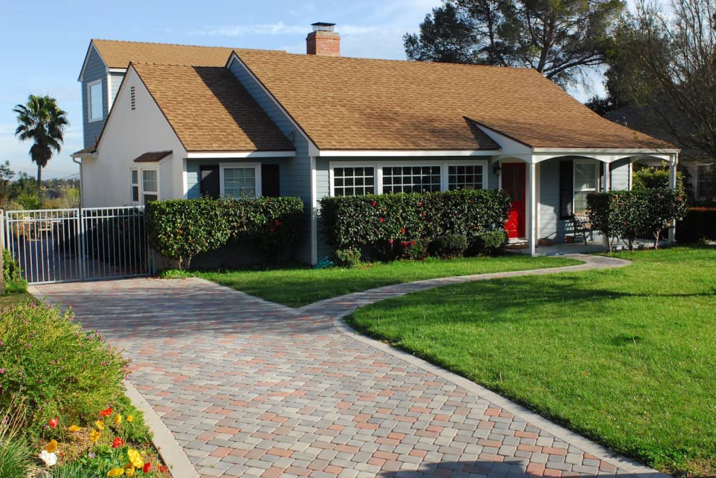 A house with a brick driveway leading to it