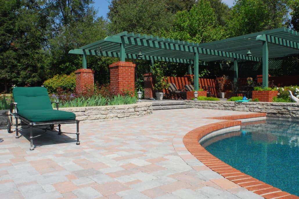 A patio with a swimming pool and a pergola
