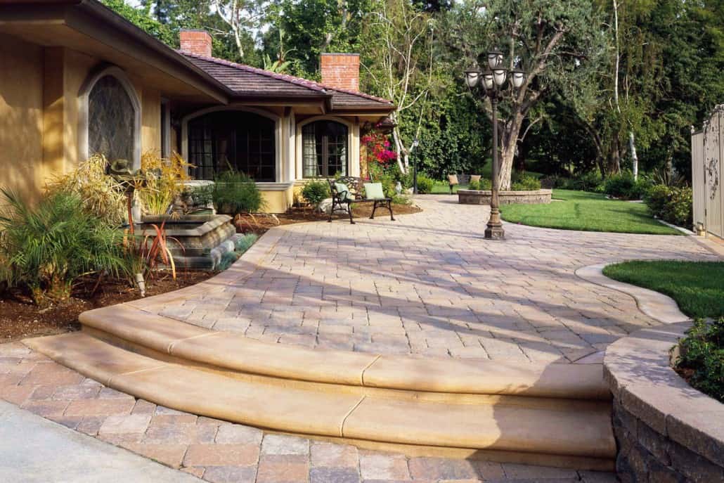 A house with a patio and stairs in front of it.