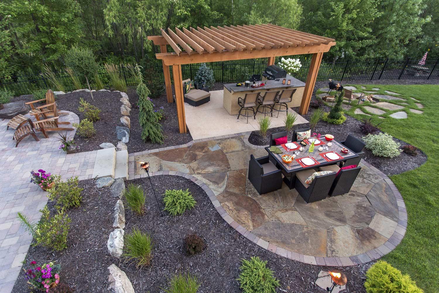 An aerial view of a patio with a table and chairs under a pergola.