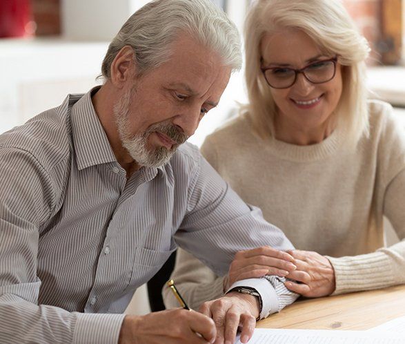 Old Couple Sign Legal Paper — Elkhart, IN — Maryellen Baker Attorney at Law Old Couple Sign Legal Paper — Elkhart, IN — Maryellen Baker Attorney at Law