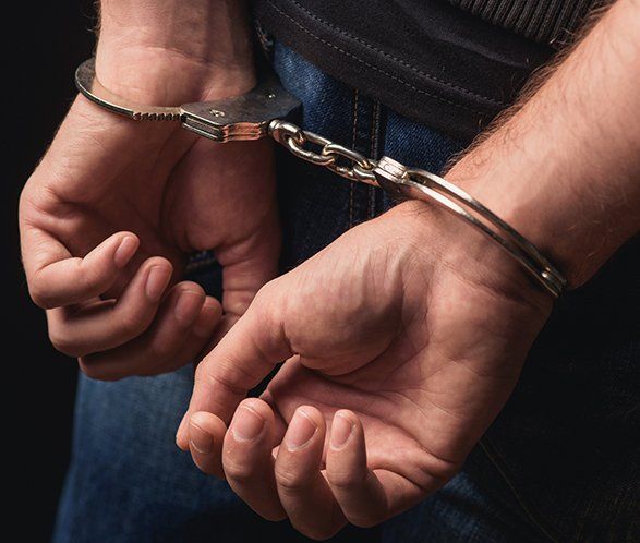 Criminal Standing in Handcuffs — Elkhart, IN — Maryellen Baker Attorney at Law Criminal Standing in Handcuffs — Elkhart, IN — Maryellen Baker Attorney at Law
