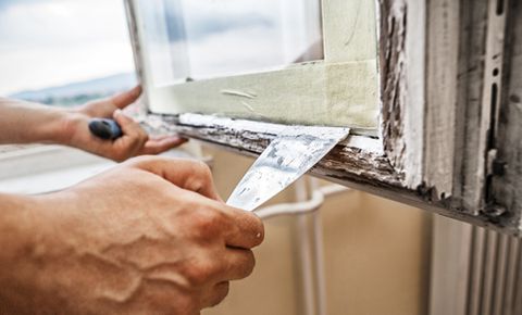 Professional repairing window's wooden frame
