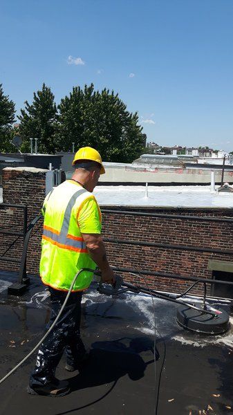 Roofing contractor cleaning roof 