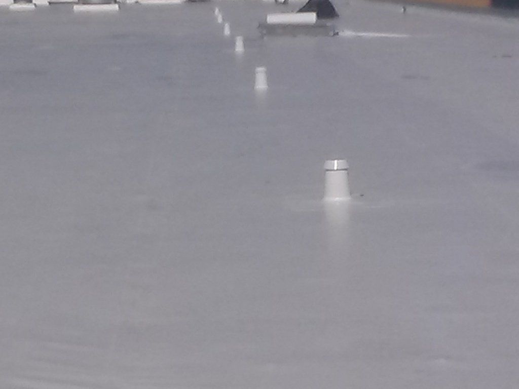 a close up of a roof with a chimney on it .