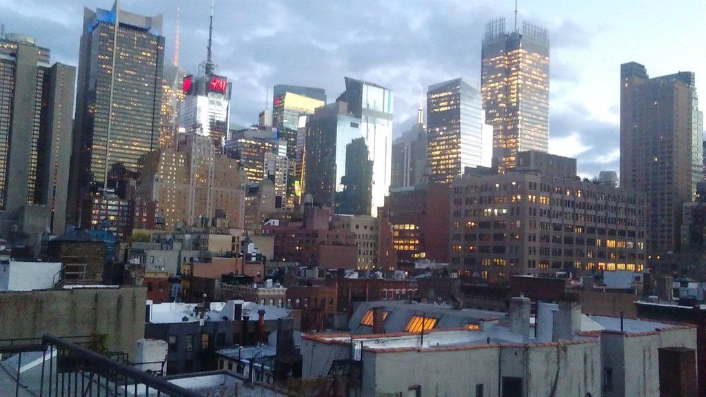a city skyline with a lot of buildings lit up at night