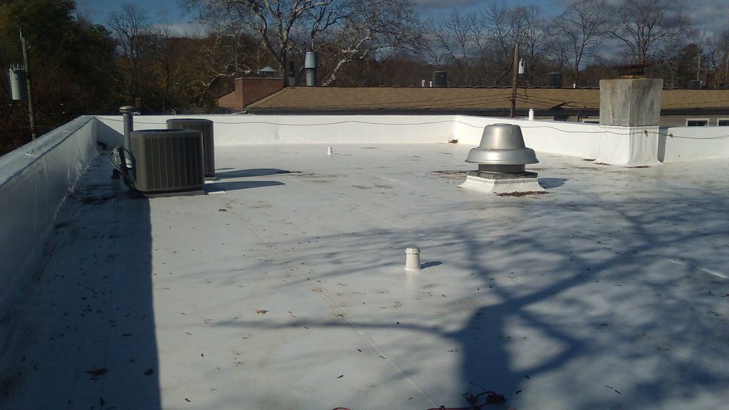 a white roof with a chimney on top of it