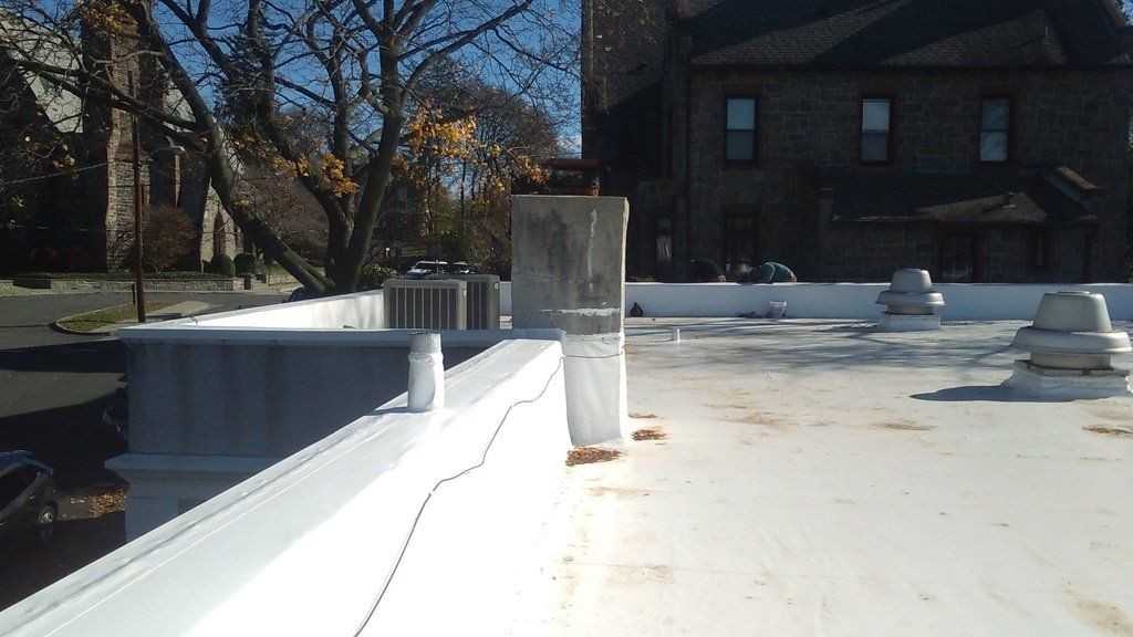 a white roof with a building in the background