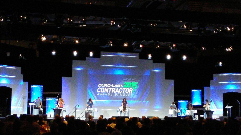 a stage with a large screen that says contractor on it