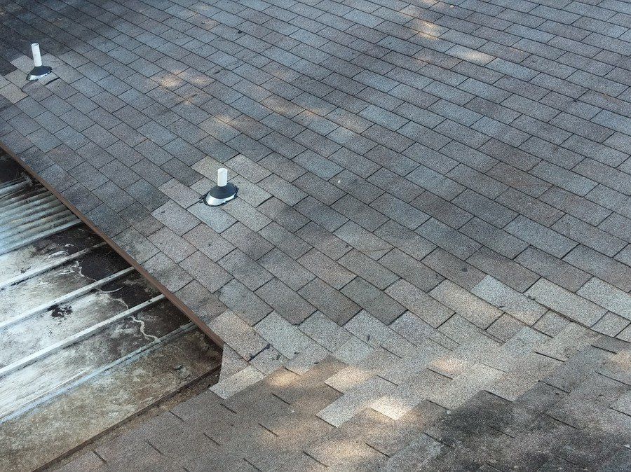 a brick walkway with a few holes in it