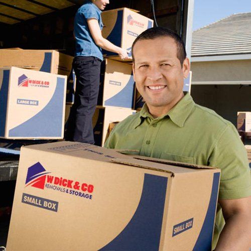 person moving boxes with W Dick & Co logo