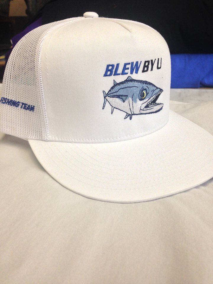 White baseball cap with blue text and a tuna illustration. The text reads 