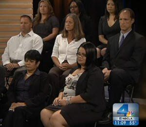 Kathryn Lindberg (center wearing white) sits with other CA National Guard whistleblowers as they are questioned by NBC News Reporters A group of people are sitting in front of a screen with the number 4 on it