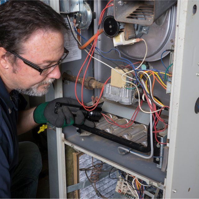 HVAC Tech working on furnace