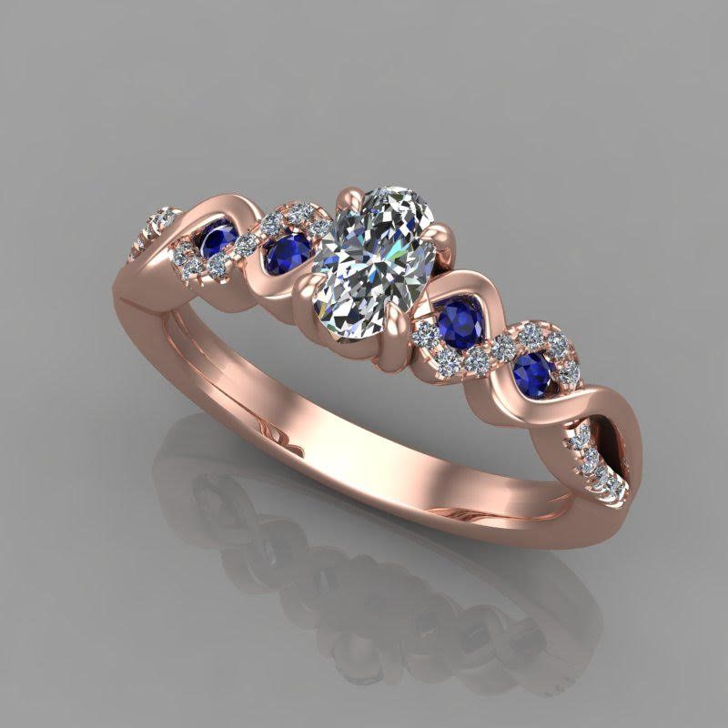 Rose gold engagement ring with oval diamond center stone, blue sapphire accents, and diamond halo.