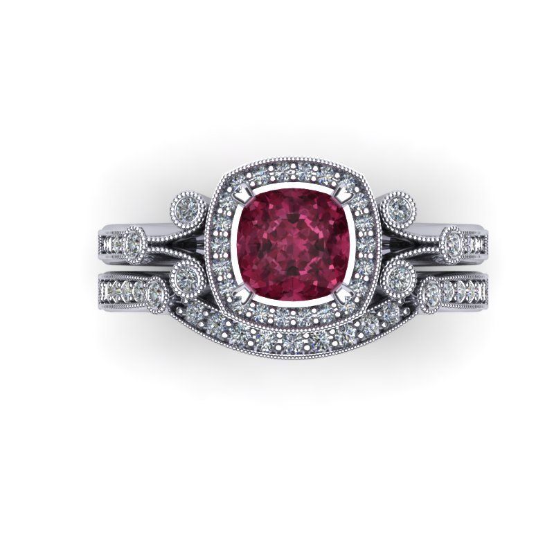 Ruby and diamond engagement ring and matching band set on a white background.
