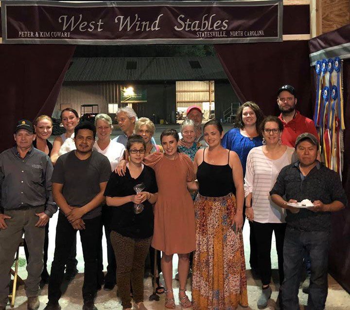 photo of West Wind Stables customers and staff in front of barn tack curtains at Gasparilla Charity Horse Show in Tampa, FL