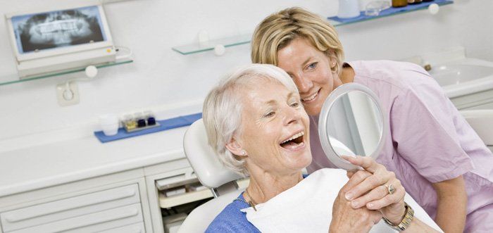 woman looking at her teeth