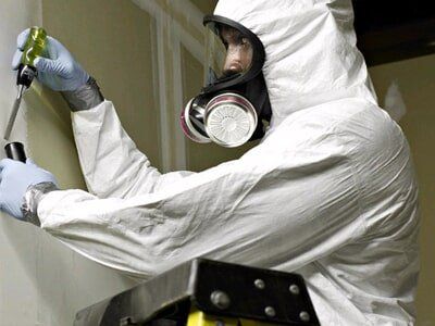 A Worker with Full Face Respirator and White Protective Suit- Asbestos Removal Near Darwin