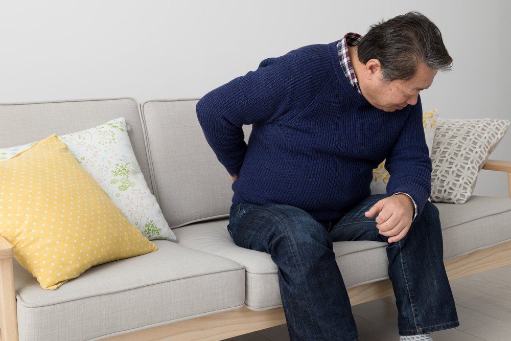 man suffering chronic lower back pain after car accident