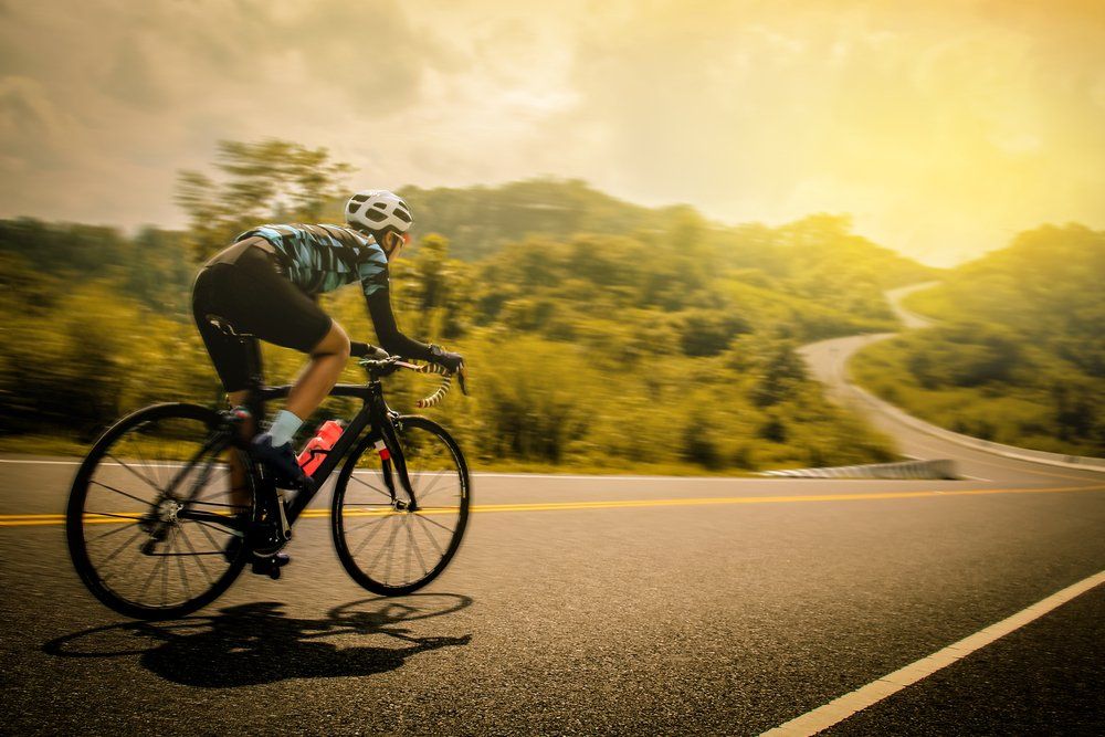 man riding a bicycle down a roadway