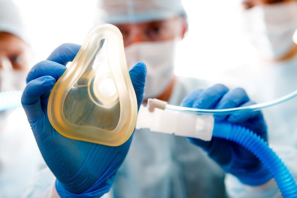 anesthesiologist holding anesthesia mask out 