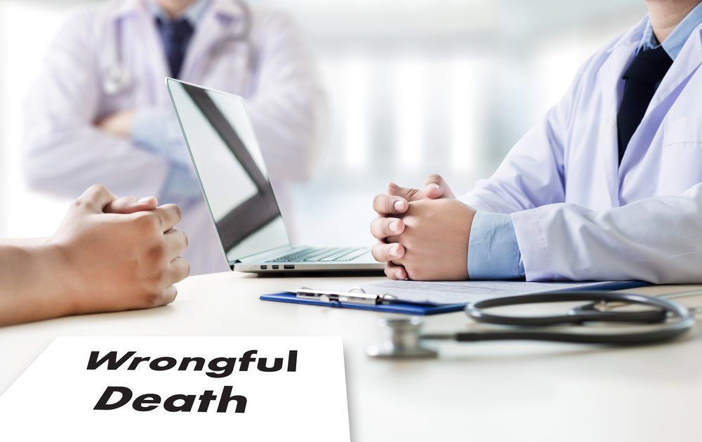 wrongful death attorney sitting at desk with doctor
