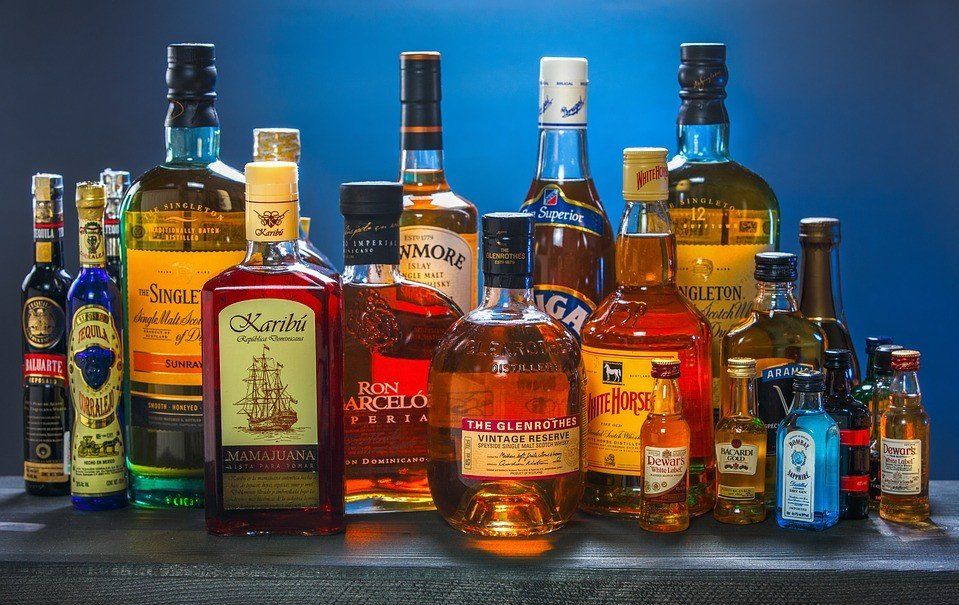 Several bottles of liquor are lined up on a table