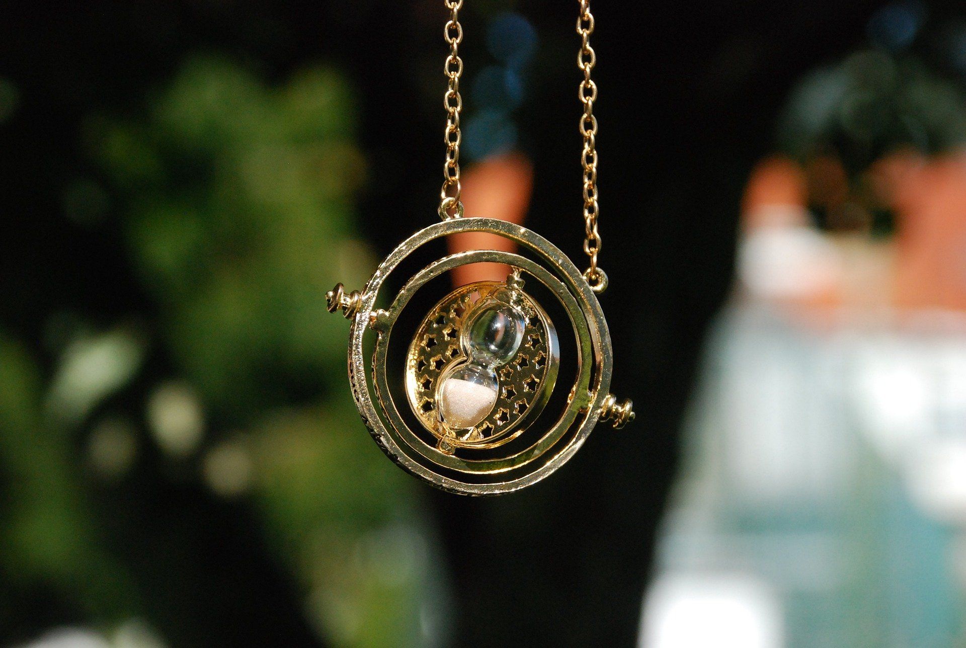 A necklace with a time turner on it