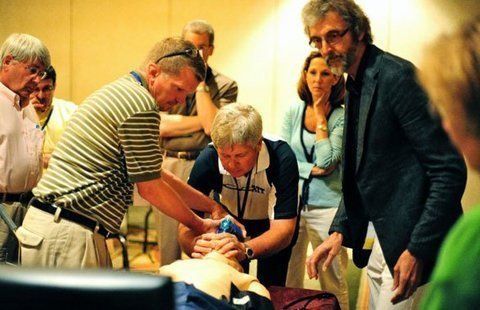 Human Simulation Lab A group of people are watching a man perform a resuscitation on another man