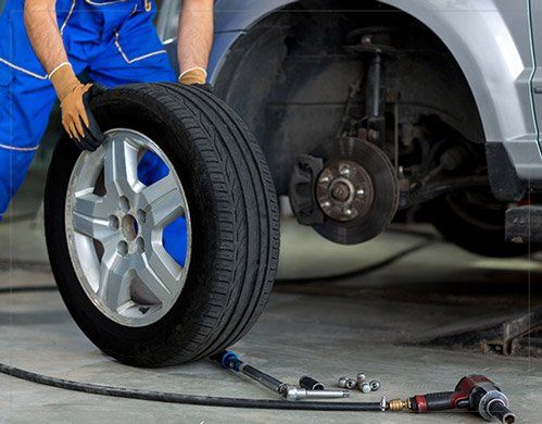 Mechanic changing wheel of a modern car - Auto Care in Gorham,ME Mechanic changing wheel of a modern car - Auto Care in Gorham,ME