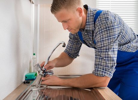 plumber fixing sink