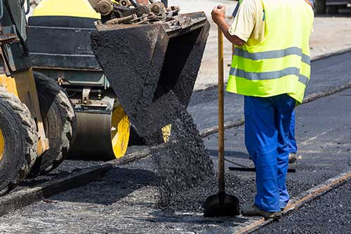 Asphalt — Worker Constructing Asphalt Road in Colorado Springs, CO