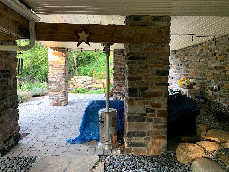A patio with a heater and a star on the ceiling.