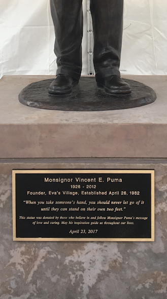 A statue of a man with a plaque on the base