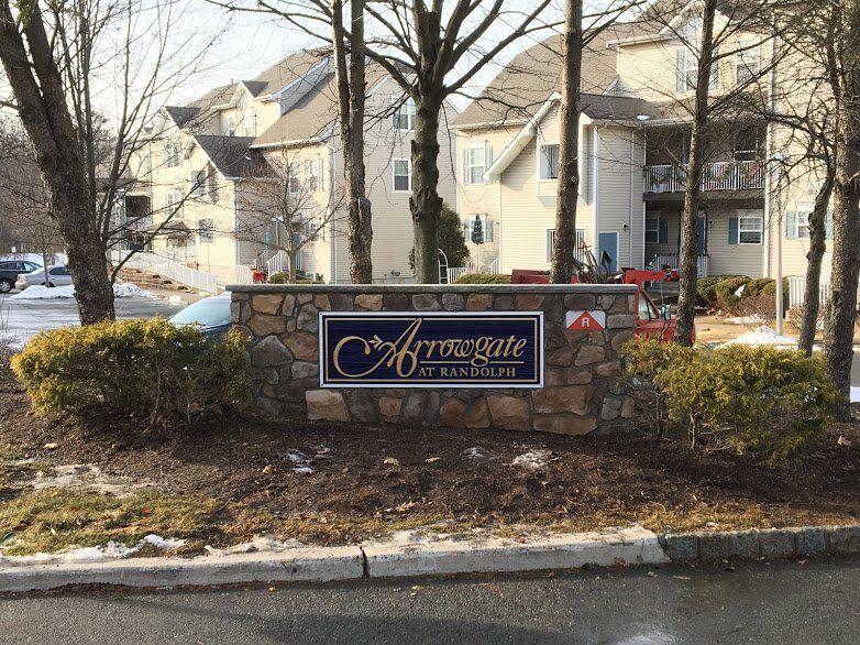 A stone wall with a sign that says acrossgate on it