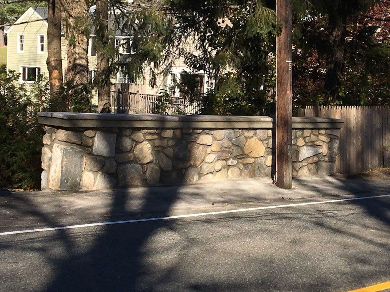A stone wall along the side of a road